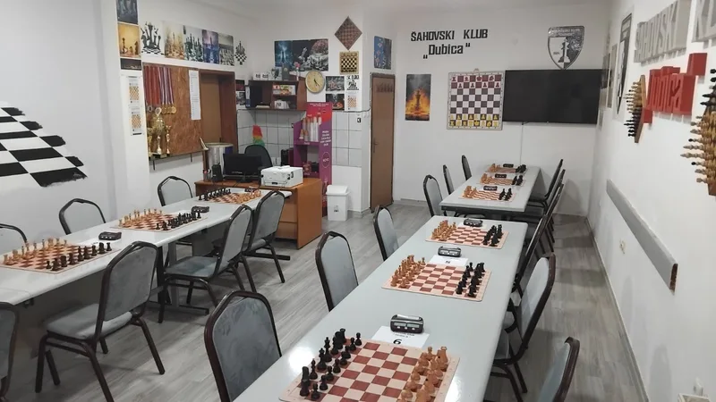 The Dubica club hall with chess boards and clocks set up for play.